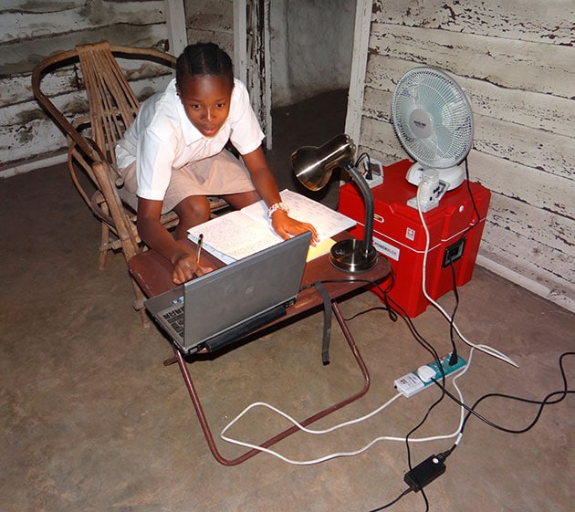 A kid doing homework on a computer in sub-Saharan Africa